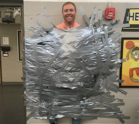 adult taped up on the school wall