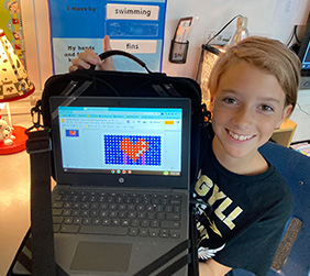 Student showing computer graphic of a heart